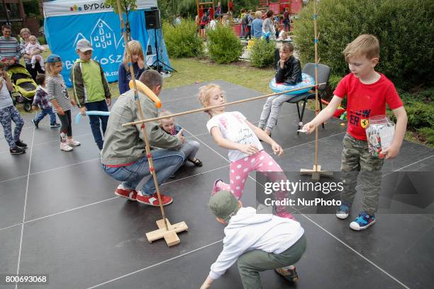 Young children are seen doing a limbo dance at a playground on the Mill Island in Bydgoszcz, Poland on 24 June, 2017.