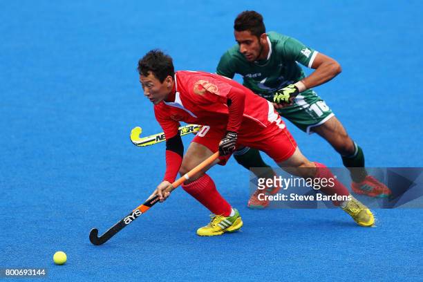 Weibao Ao of China and Ammad Shakeel of Pakistan battle for possession during the 7th/8th place match between Pakistan and China on day nine of the...