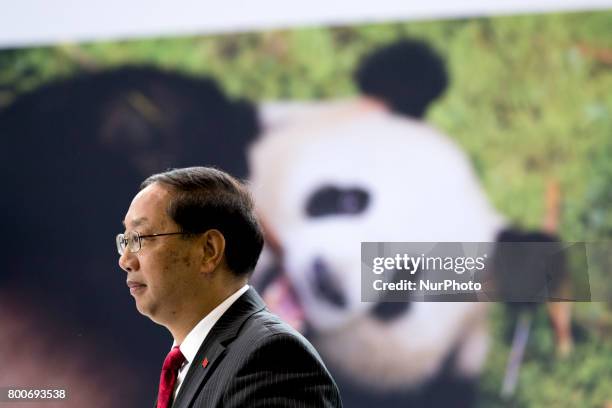 Chinese Ambassador to Germany Shi Mingde takes pictures with his phone at the arrival of panda couple Meng Meng and Jiao Qing at the cargo terminal...