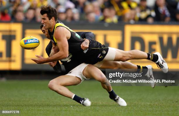 Alex Rance of the Tigers is tackled by Kade Simpson of the Blues during the 2017 AFL round 14 match between the Richmond Tigers and the Carlton Blues...