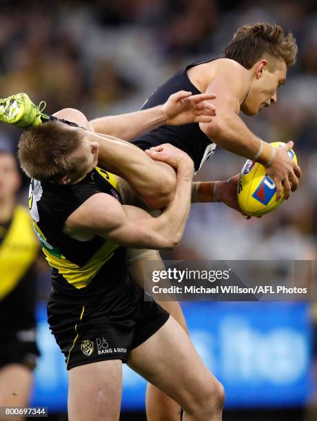 Patrick Cripps of the Blues takes a spectacular mark over Jack Riewoldt of the Tigers during the 2017 AFL round 14 match between the Richmond Tigers...
