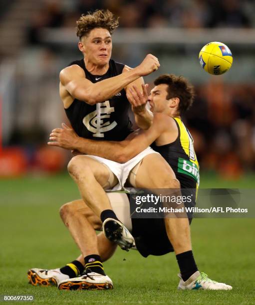 Charlie Curnow of the Blues is tackled by Alex Rance of the Tigers during the 2017 AFL round 14 match between the Richmond Tigers and the Carlton...