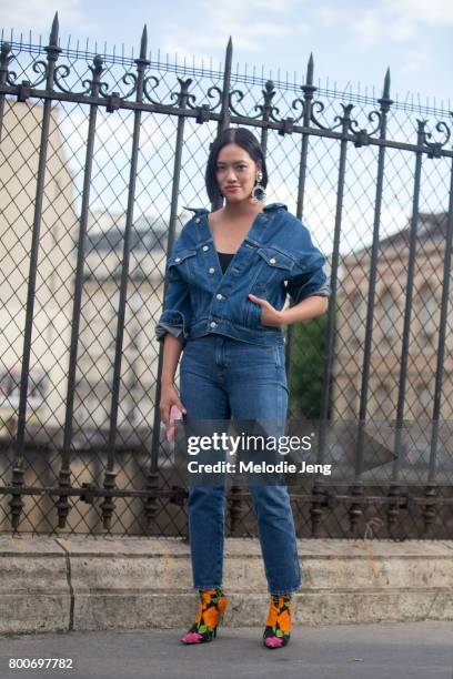 Tiffany Hsu wears a denim outfit and Balenciaga shoes outside the Vetements SS18 "NO SHOW" event on June 24, 2017 in Paris, France.