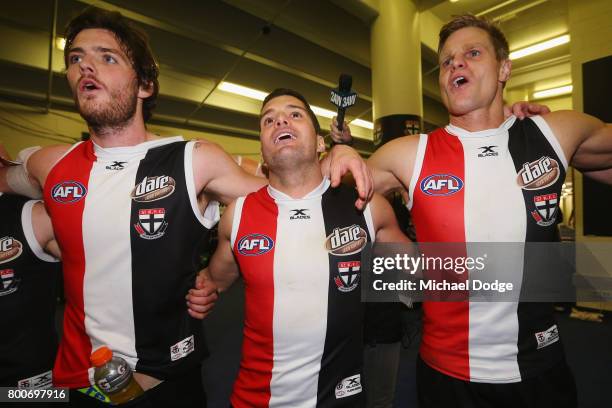 Dylan Roberton Leigh Montagna and Nick Riewoldt of the Saints sing the club song after winning during the round 14 AFL match between the St Kilda...