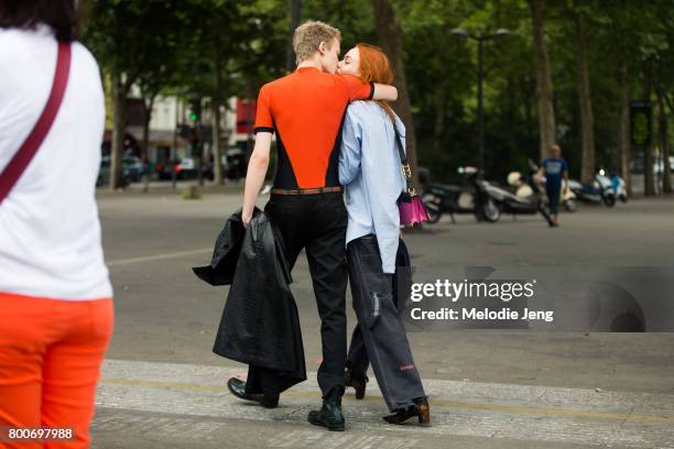 Model couple Kiki Willems, Jonas Gloer share a kiss outside the Sacai show on June 24, 2017 in Paris, France.