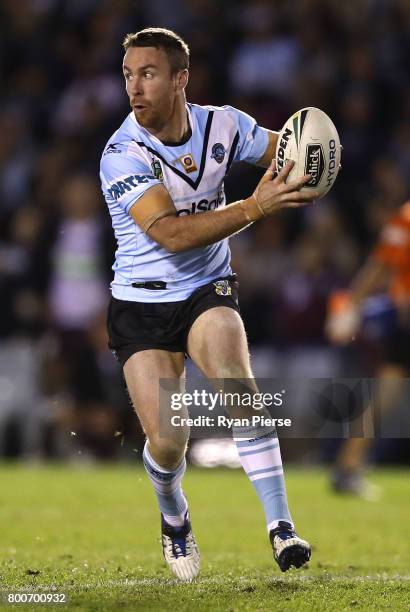 James Maloney of the Sharks passes during the round 16 NRL match between the Cronulla Sharks and the Manly Sea Eagles at Southern Cross Group Stadium...