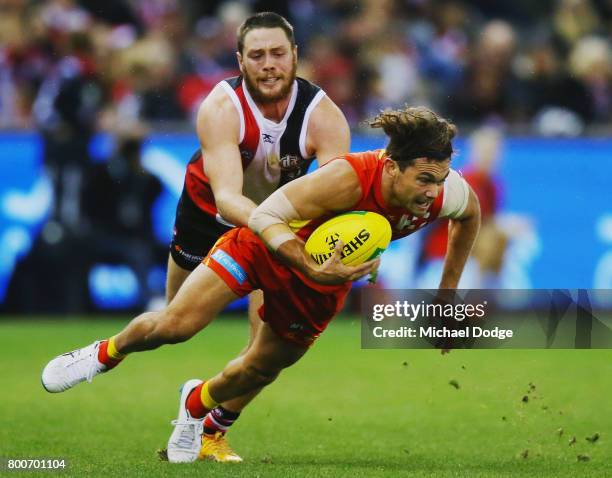 Jack Steven of the Saints tackles Jarrod Harbrow of the Suns during the round 14 AFL match between the St Kilda Saints and the Gold Coast Suns at...