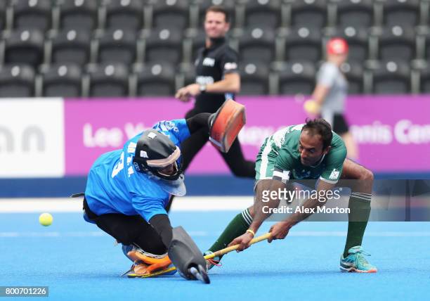 Muhammad Umar Bhutta of Pakistan scores his sides second goal past Zhiwei Ao of China during the 7th/8th place match between Pakistan and China on...