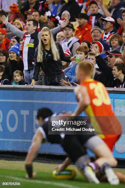 Saints fans react after an umpiring decision during the round 14 AFL match between the St Kilda Saints and the Gold Coast Suns at Etihad Stadium on...