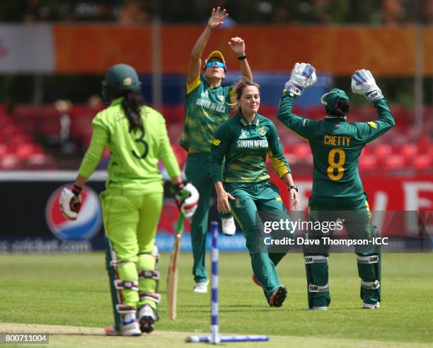 Dane van Niekerk of South Africa, celebrates with wicket keeper Trisha Chetty of South Africa after she stumped Bismah Maroof of Pakistan during the...