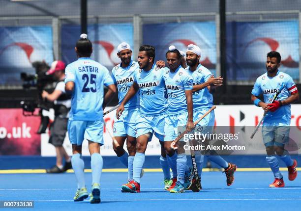 Harmanpreet Singh of India celebrates scoring their teams second goal with teammates during the 5th/6th place match between India and Canada on day...