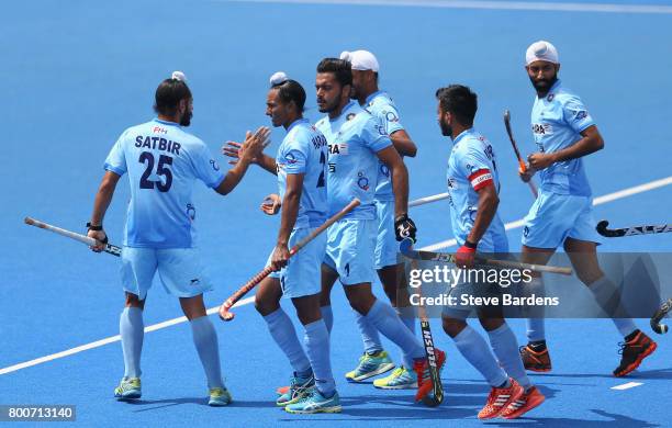 Harmanpreet Singh of India celebrates scoring their teams second goal with teammates during the 5th/6th place match between India and Canada on day...