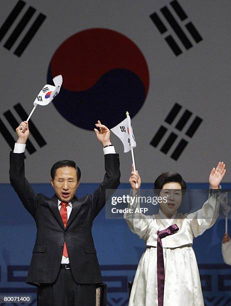 South Korean President Lee Myung-bak and his wife Kim Yoon-ok wave national flags and cheer at the 89th anniversary of the Independence Movement...