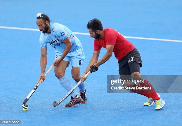 Sardar Singh of India and Sukhi Panesar of Canada battle for possession during the 5th/6th place match between India and Canada on day nine of the...