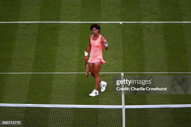 Carla Suarez Navarro of Spain celebrates winning a point during her main draw match against Ekaterina Makarova of Russia during day one of the Aegon...