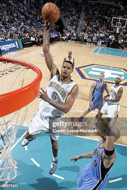 Tyson Chandler of the New Orleans Hornets shoots over Carlos Boozer of the Utah Jazz on February 29, 2008 at the New Orleans Arena in New Orleans,...