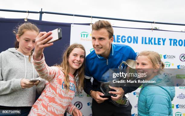 Marton Fucsovics of Hungary takes some selfies with fans after winning the men's singles final on June 25, 2017 in Ilkley, England.