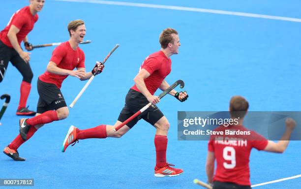 Gordan Johnston of Canada celebrates scoring their teams third goal with teammates during the 5th/6th place match between India and Canada on day...