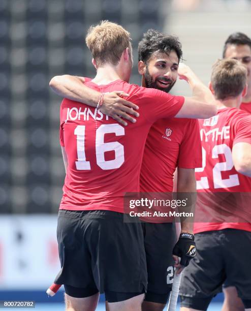 Gordan Johnston of Canada and Sukhi Panesar of Canada embrace after the 5th/6th place match between India and Canada on day nine of the Hero Hockey...
