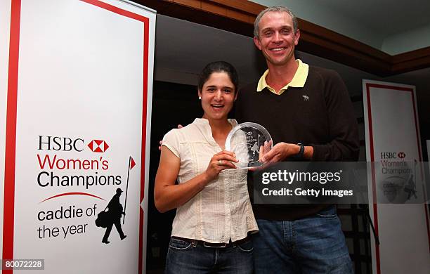 David Brooker poses with the trophy alongside his boss Lorena Ochoa after being named Caddie Of The Year after the second round of the HSBC Women's...