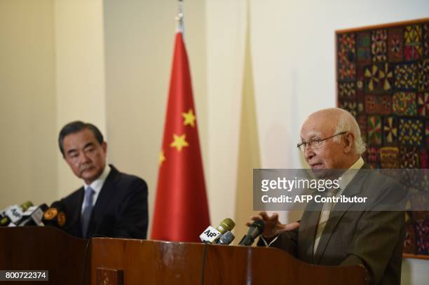 Chinese Foreign Minister Wang Yi and Pakistani Advisor to the Prime Minister on National Security and Foreign Affairs Sartaj Aziz attend a press...