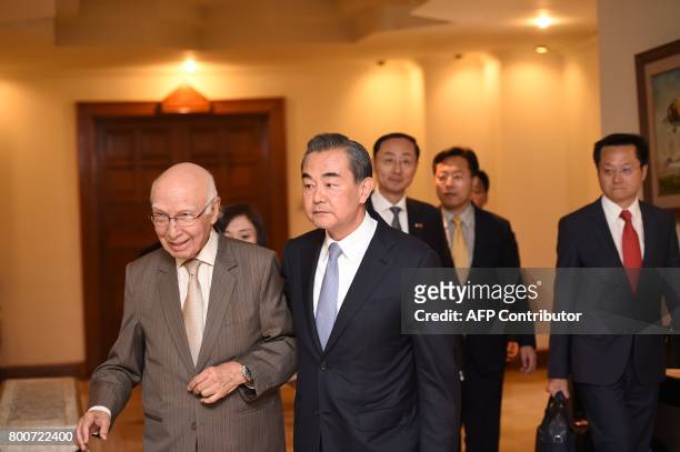Chinese Foreign Minister Wang Yi and Pakistani Advisor to the Prime Minister on National Security and Foreign Affairs Sartaj Aziz arrive for a press...