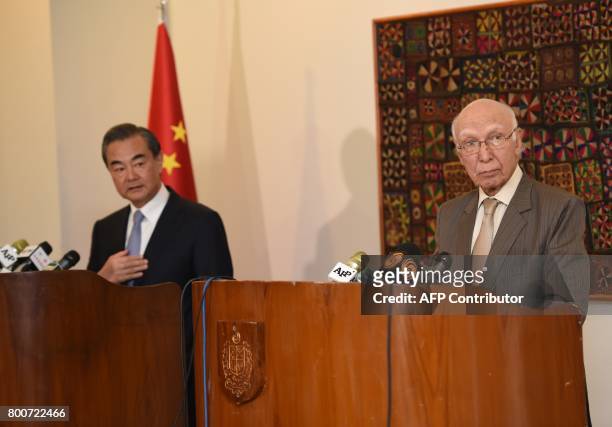 Chinese Foreign Minister Wang Yi and Pakistani Advisor to the Prime Minister on National Security and Foreign Affairs Sartaj Aziz attend a press...