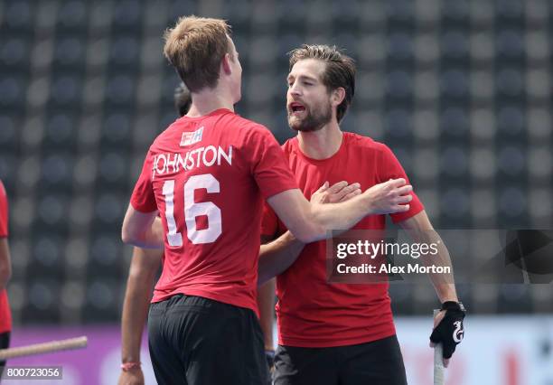 Gordan Johnston of Canada and Iain Smythe of Canada embrace after the 5th/6th place match between India and Canada on day nine of the Hero Hockey...