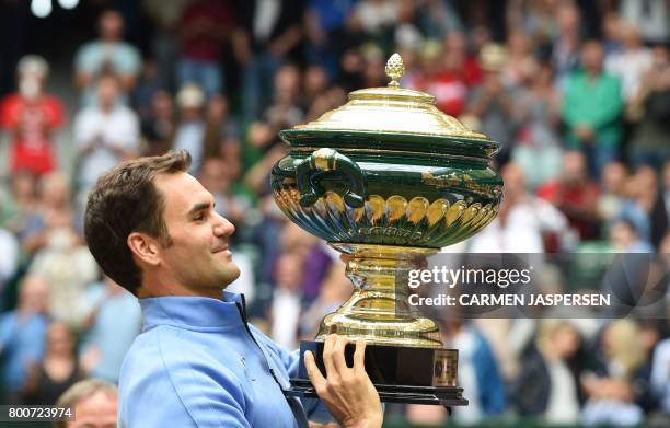 Roger Federer from Switzerland poses with his trophy after winning his final match against Alexander Zverev from Germany at the Gerry Weber Open...