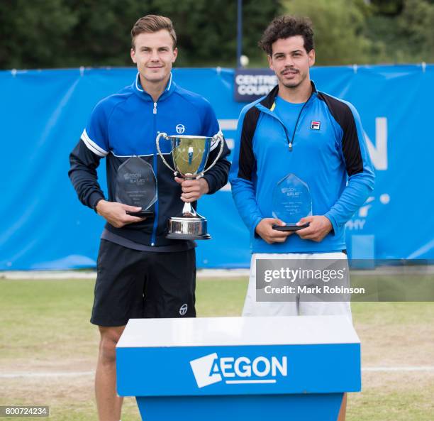 Marton Fucsovics of Hungary with his winners trophy and Alex Bolt of Australia with his runners up trophy after the men's singles final on June 25,...