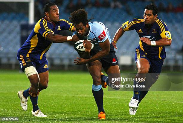 Lote Tuqiri of the Waratahs is tackled during the round three Super 14 match between the Highlanders and the New South Wales Waratahs held at...