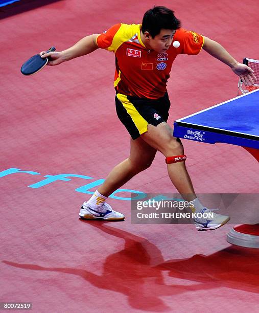 China's Wang Hao serves against Hong Kong's Cheung Yuk during the men's semi-final and position match at the World Team Table Tennis Championships in...