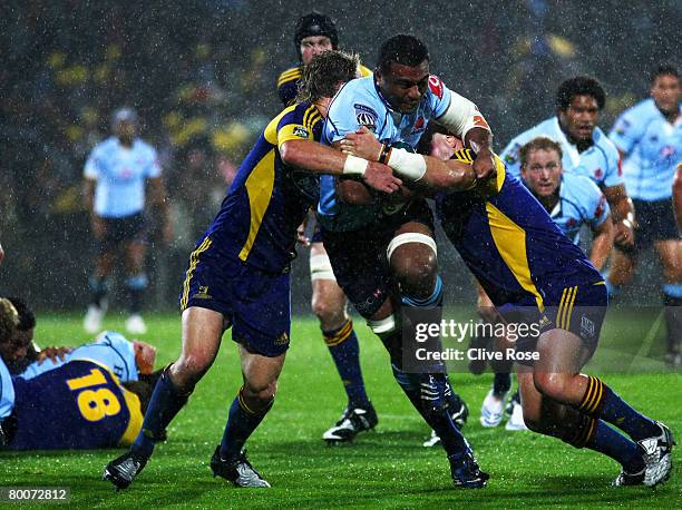 Wycliff Palu of the Waratahs is tackled during the round three Super 14 match between the Highlanders and the New South Wales Waratahs held at...