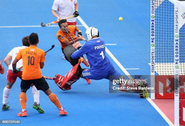 Azuan Hasan of Malaysia has a shot saved by George Pinner of England during the 3rd/4th place match between Malaysia and England on day nine of the...