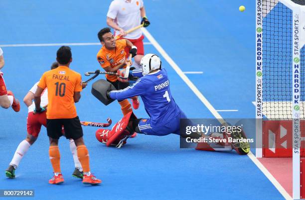 Azuan Hasan of Malaysia has a shot saved by George Pinner of England during the 3rd/4th place match between Malaysia and England on day nine of the...