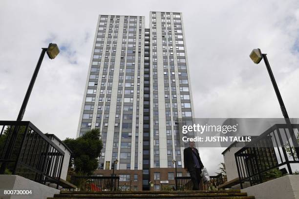 Man walks past Dorney Tower residential block on the Chalcots Estate in north London on June 25, 2017. Thousands of residents from 650 London flats...