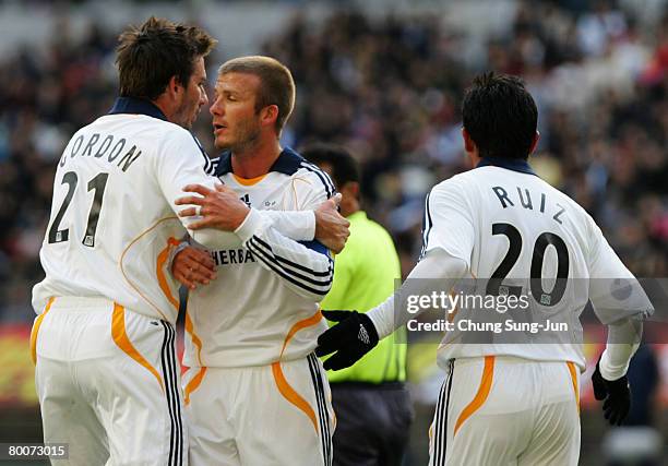 Alan Gordon of LA Galaxy celebrates with his team mate David Beckham after scoring a goal during a friendly match between FC Seoul v LA Galaxy on...