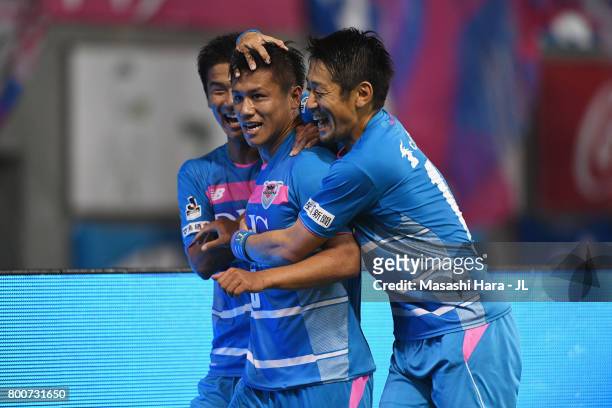 Yuji Ono of Sagan Tosu celebrates scoring the opening goal with his team mates Akito Fukuta and Yoshiki Takahashi during the J.League J1 match...