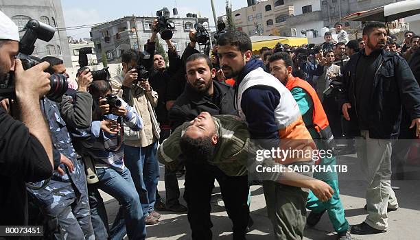 Palestinian medical workers carry a wounded man into a hospital at Beit Lahia in the northern Gaza Strip on March 1, 2008. Israel pressed its assault...