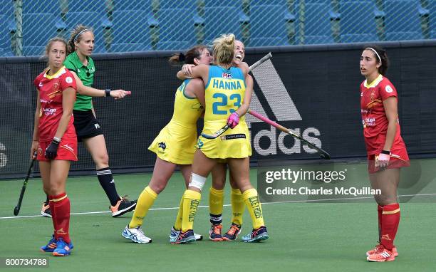 Emily Smith of Australia is hugged by team mates after scoring during the FINTRO Women's Hockey World League Semi-Final Pool B game between Australia...