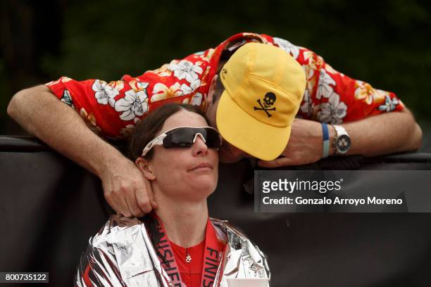 Second pace athlete Elaine Garvicanfrom Great Britain receives kisses from a relative at the finish line during the Ironman 70.3 UK Exmoor at...