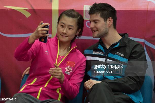 Men's single winner Dimitrij Ovtcharov of Germany and Women's single winner Ding Ning of China take selfies during the awards ceremony of 2017 ITTF...