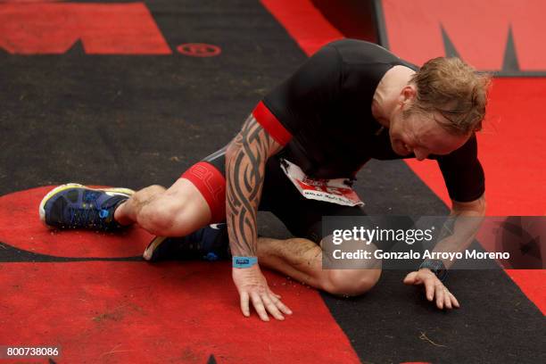 An athlete falls as he crosses the finish line during the Ironman 70.3 UK Exmoor at Wimbleball Lake on June 25, 2017 in Somerset, United Kingdom.