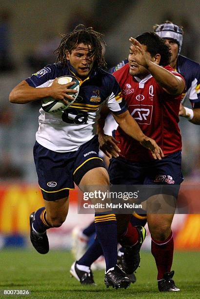 Saia Faingaa of the Brumbies tries to beat Rodney Blake of the Reds during the round three Super 14 match between the ACT Brumbies and the Queensland...