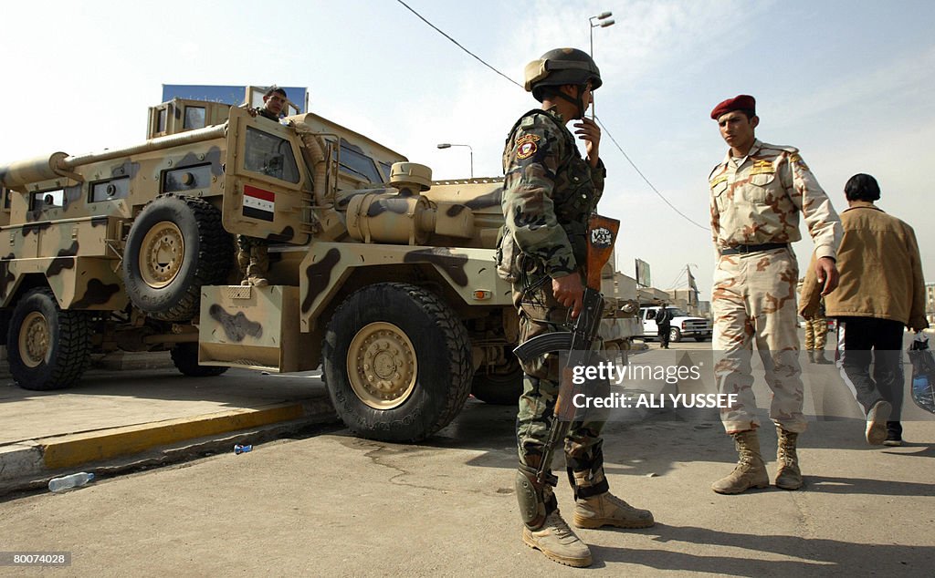 Iraqi soldiers stand guard at a checkpoi