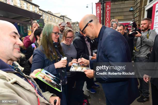 American actor, writer, producer and film director Stanley Tucci signs autographs to fans after the photocall for the event 'In Person: Stanley...