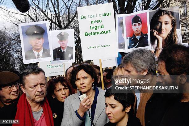 French journalist and former hostage in Iraq Florence Aubenas delivers a speech in Paris on March 1 as French theater director Robert Hossein ,...