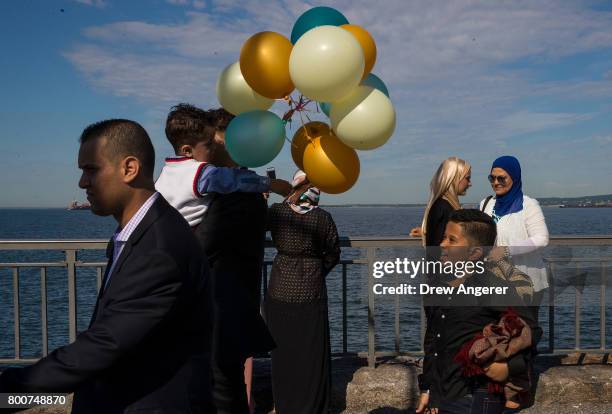 Muslim worshippers depart a group prayer service during Eid al-Fitr, which marks the end of the Muslim holy month of Ramadan, in Bensonhurst Park in...