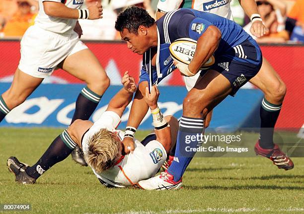 Jacques-Louis Potgieter of Cheethas tackles Isaia Toeava of Blues during the Super 14 match between Cheethas and Blues held at Vodacom Park March 1,...