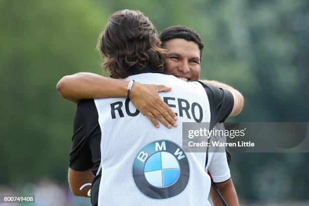 Andres Romero of Argentina embraces his caddie on the 18th green during the final round of the BMW International Open at Golfclub Munchen Eichenried...